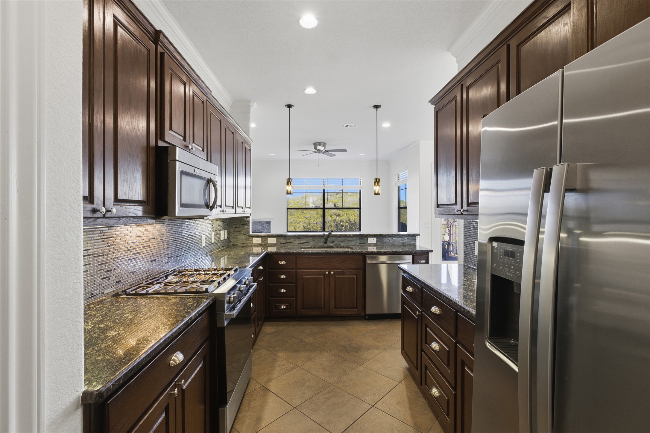 4000 Ranch Road 620 North, Unit 19 Austin, TX 78734 - Photo 11 of 39 a kitchen with granite countertop stainless steel appliances and wooden cabinets