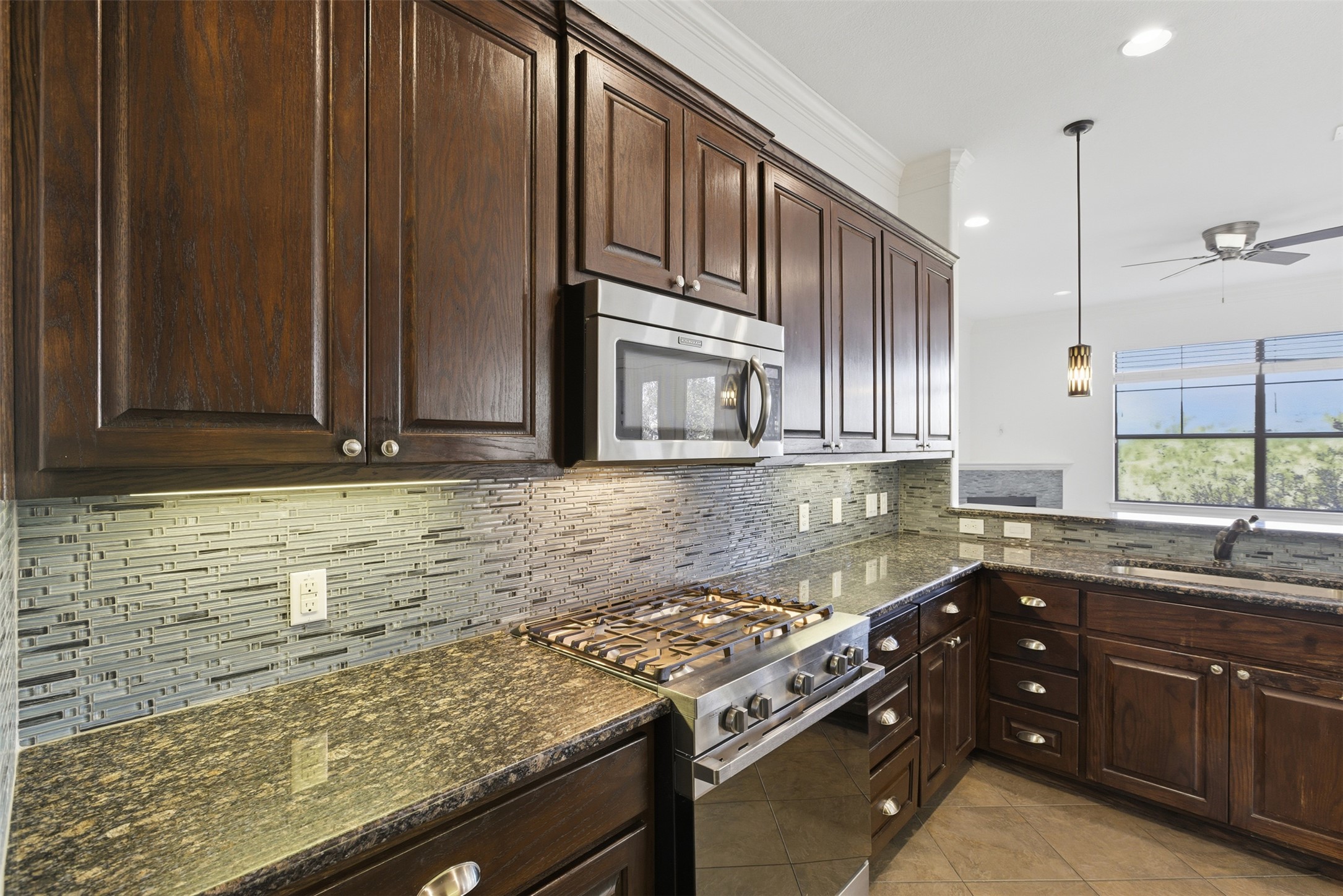 4000 Ranch Road 620 North, Unit 19 Austin, TX 78734 - Photo 12 of 39 a kitchen with stainless steel appliances granite countertop wooden cabinets and a stove top oven