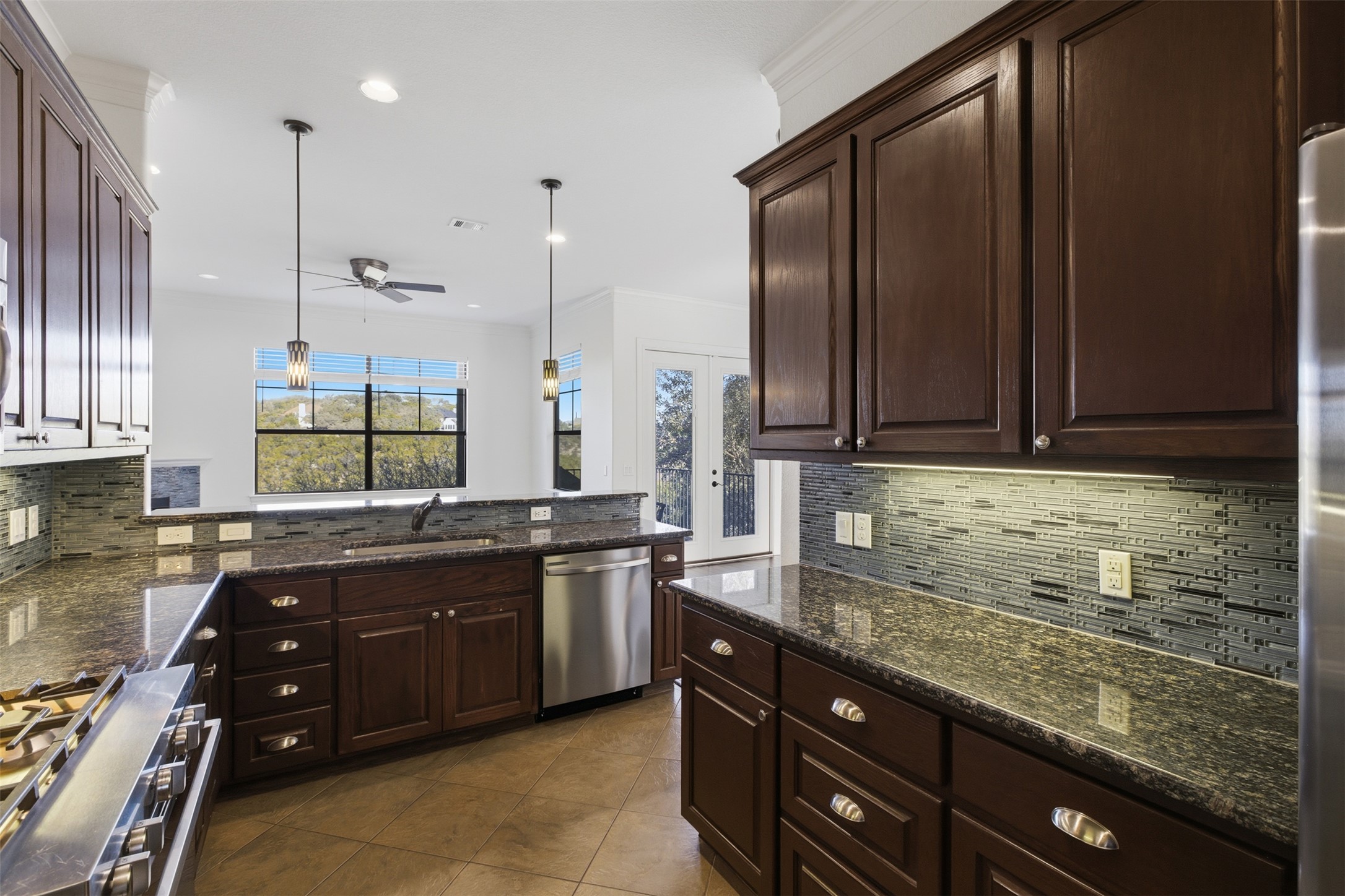 4000 Ranch Road 620 North, Unit 19 Austin, TX 78734 - Photo 13 of 39 a kitchen with a sink and wooden cabinets