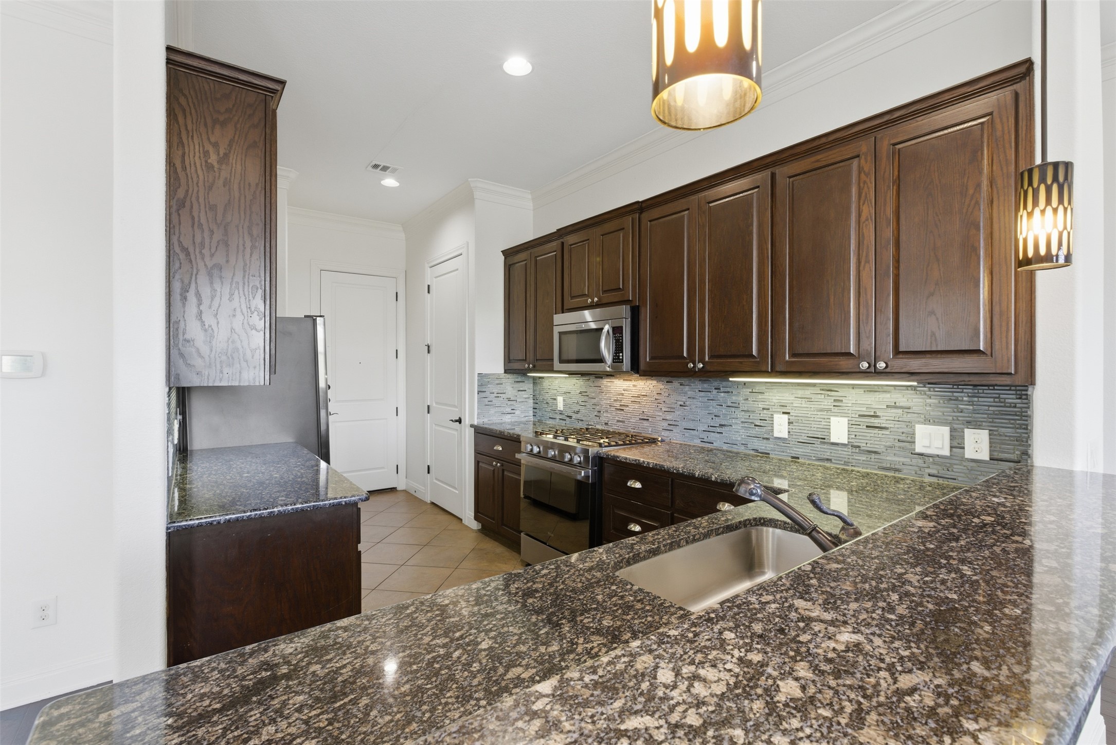 4000 Ranch Road 620 North, Unit 19 Austin, TX 78734 - Photo 14 of 39 a kitchen with granite countertop a sink stove and cabinets