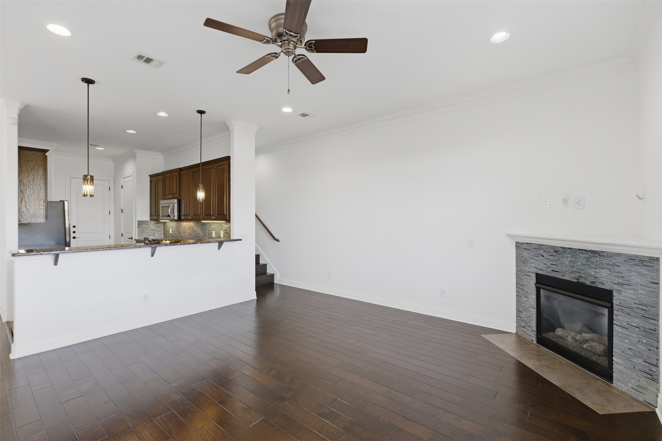 4000 Ranch Road 620 North, Unit 19 Austin, TX 78734 - Photo 10 of 39 a view of a kitchen with a fireplace and a ceiling fan