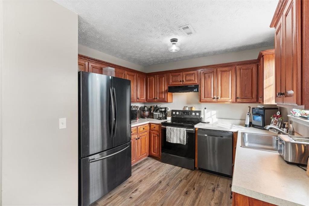 8 Stonegate Drive Cedartown, GA 30125 - Photo 11 of 42 a kitchen with stainless steel appliances granite countertop a refrigerator stove sink and cabinets