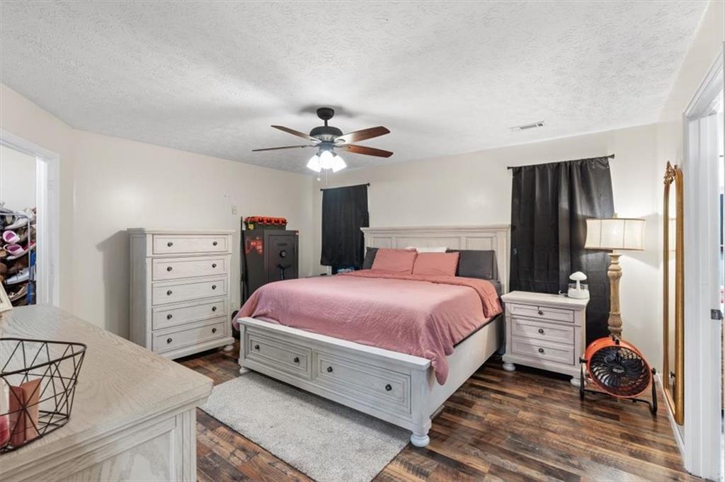 8 Stonegate Drive Cedartown, GA 30125 - Photo 16 of 42 a bedroom with a bed and a chandelier