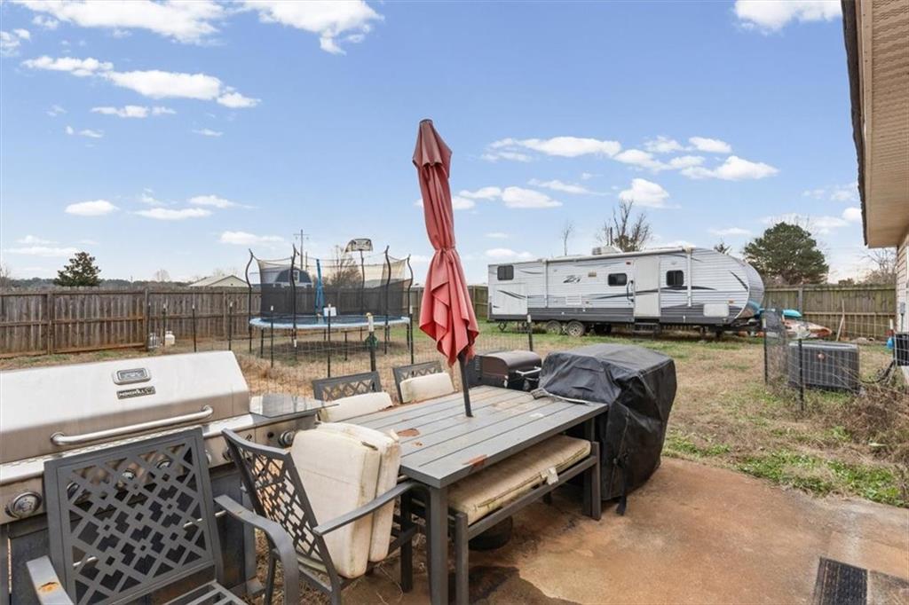 8 Stonegate Drive Cedartown, GA 30125 - Photo 28 of 42 a view of a terrace with furniture and a yard