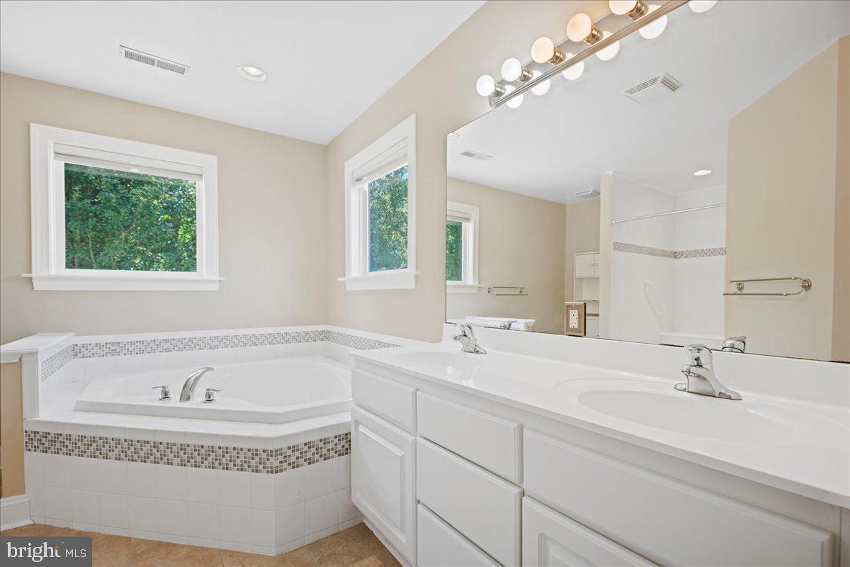 20663 Hermanville Road Lexington Park, MD 20653 - Photo 29 of 39 Primary suite with soaking tub and shower.