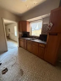 a large kitchen with stainless steel appliances granite countertop a stove a sink and a refrigerator