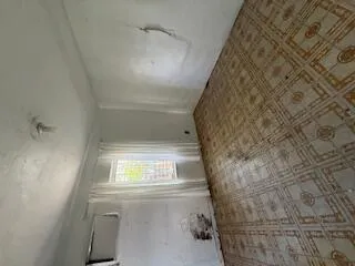 an empty room with a empty space and windows