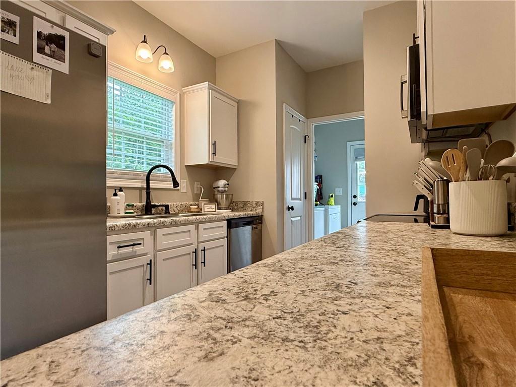 1776 Pleasant Grove Road Temple, GA 30179 - Photo 10 of 45 a kitchen with a stove a sink and a refrigerator
