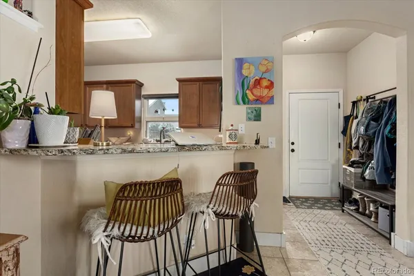 a bathroom with a granite countertop sink a toilet and shower