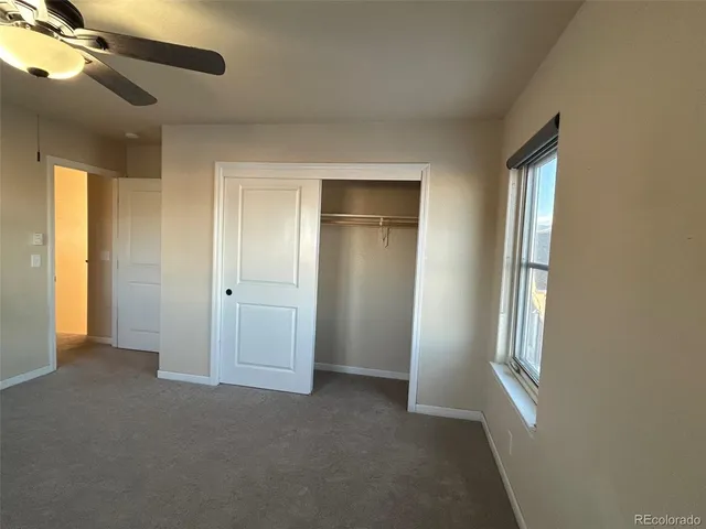 an empty room with windows and closet