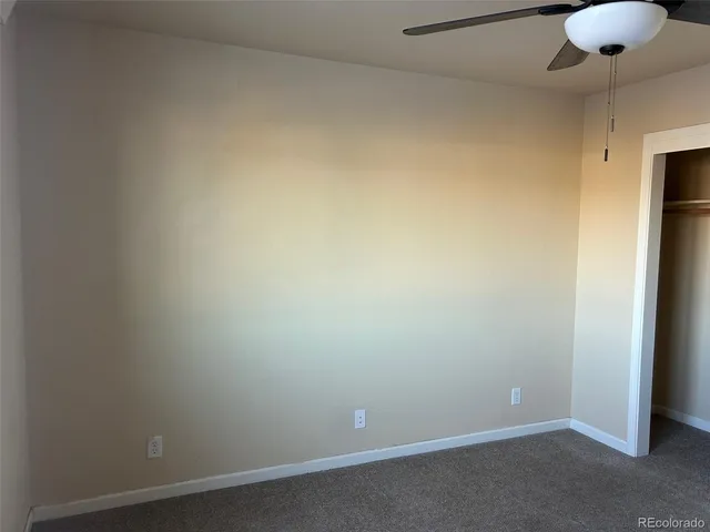 a view of walk in closet with a ceiling fan