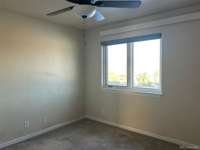 an empty room that has a window and painted walls