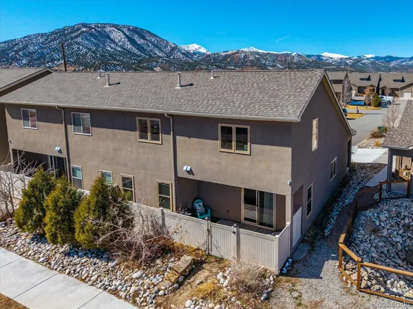 a walk in closet with wooden floor