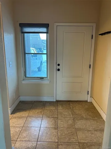 an empty room with window and doors