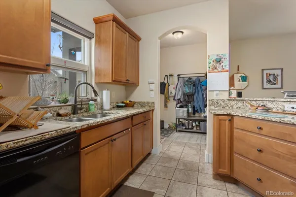 a bathroom with a granite countertop sink a toilet and shower