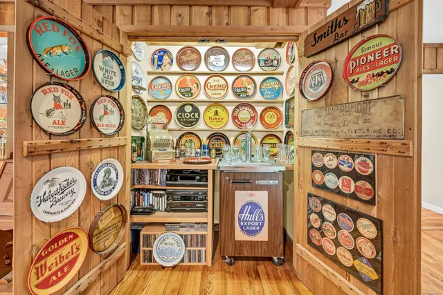 a living room with furniture a rug and a bookshelf