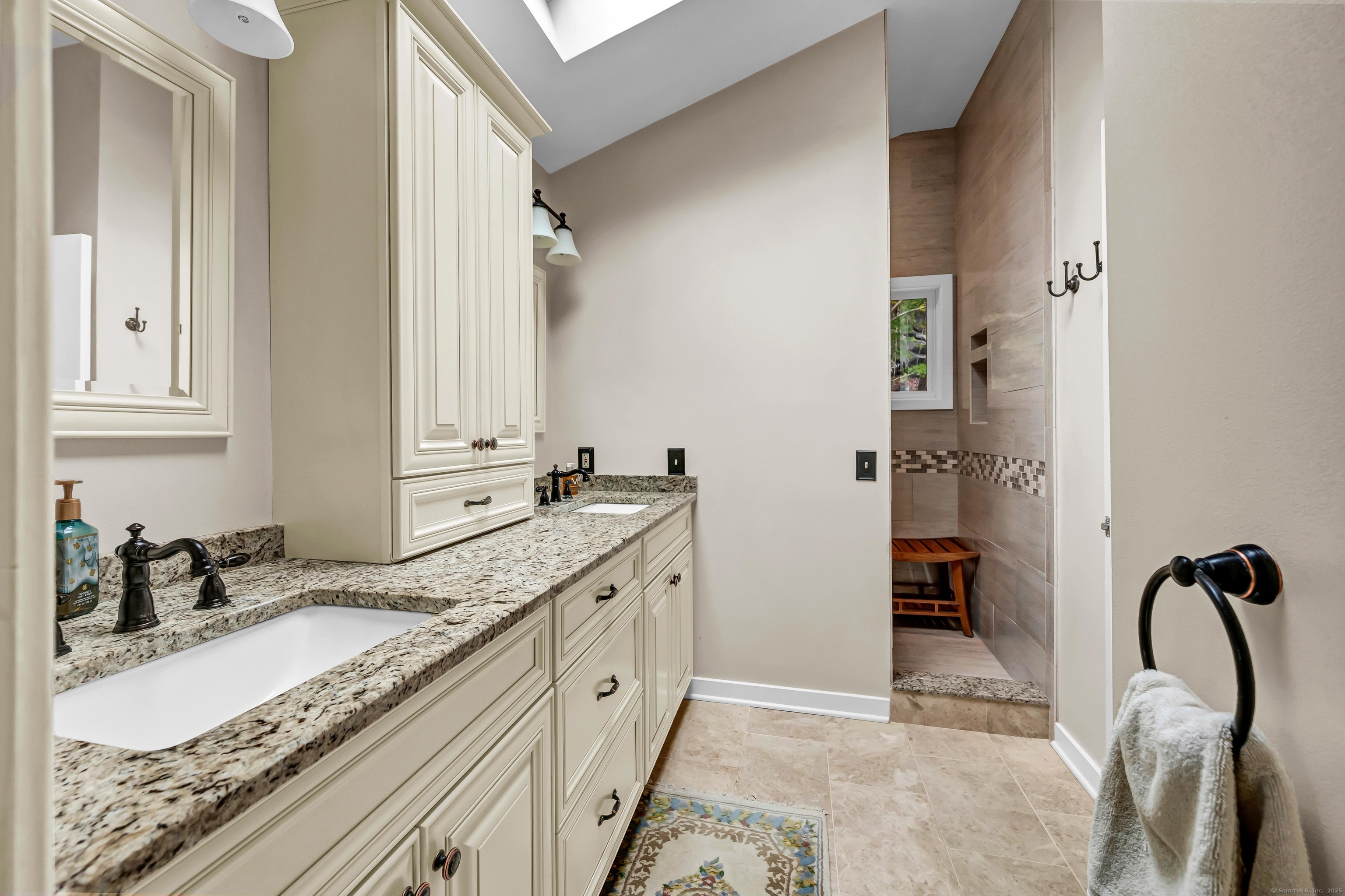 26 Cove Road Brookfield, CT 06804 - Photo 26 of 40 a spacious bathroom with a granite countertop sink and a mirror