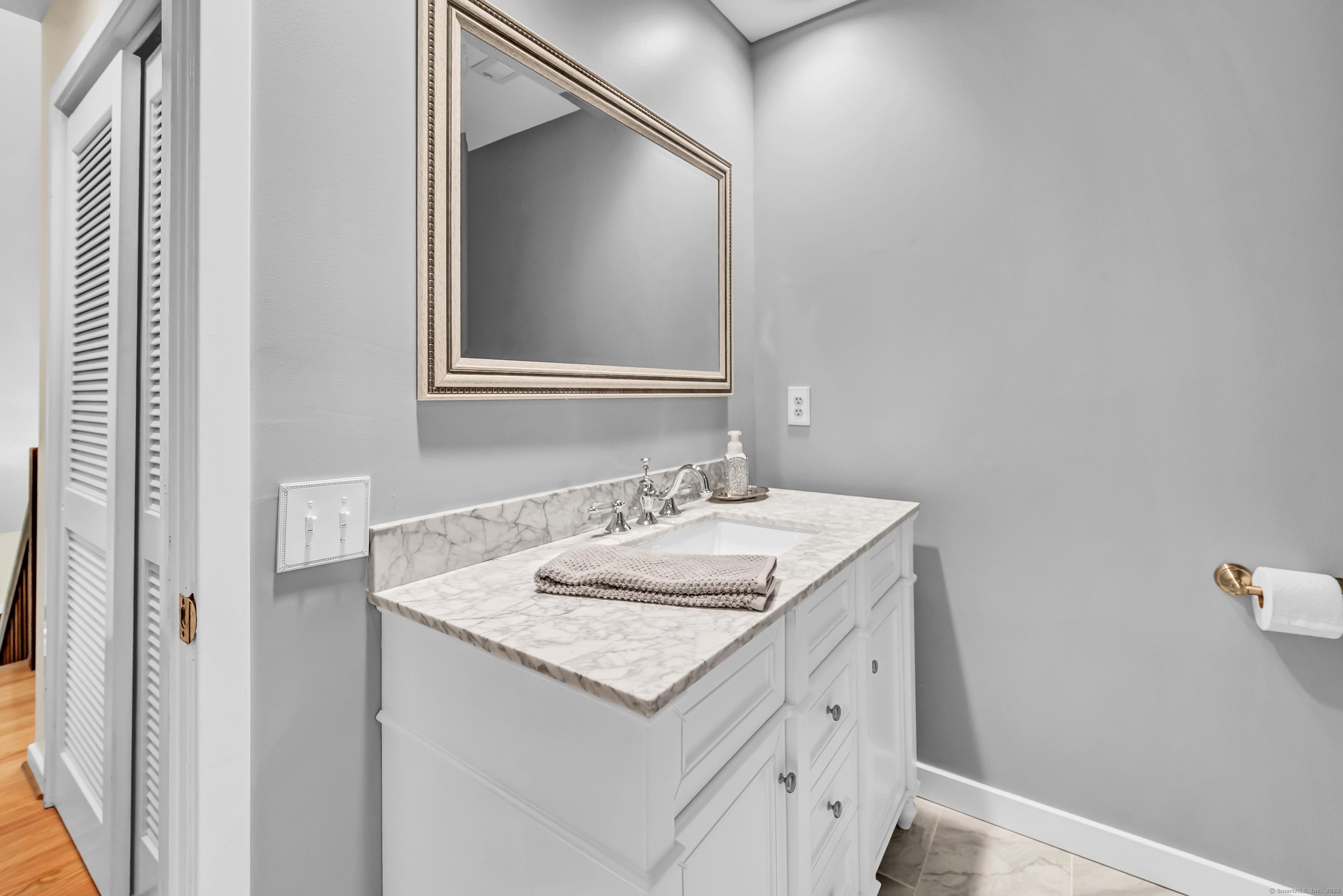 26 Cove Road Brookfield, CT 06804 - Photo 32 of 40 a bathroom with a granite countertop sink and a mirror