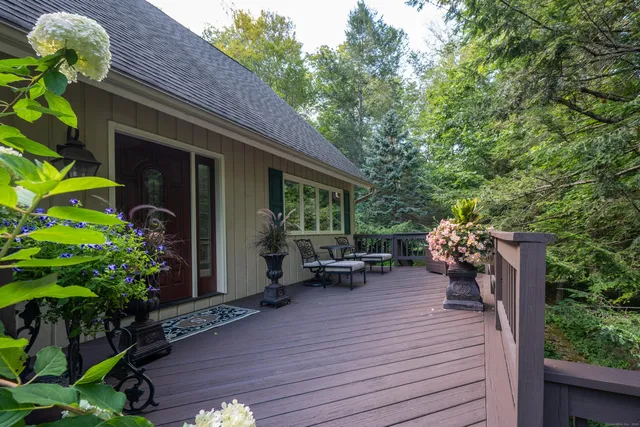 a view of a lake with a yard and large trees