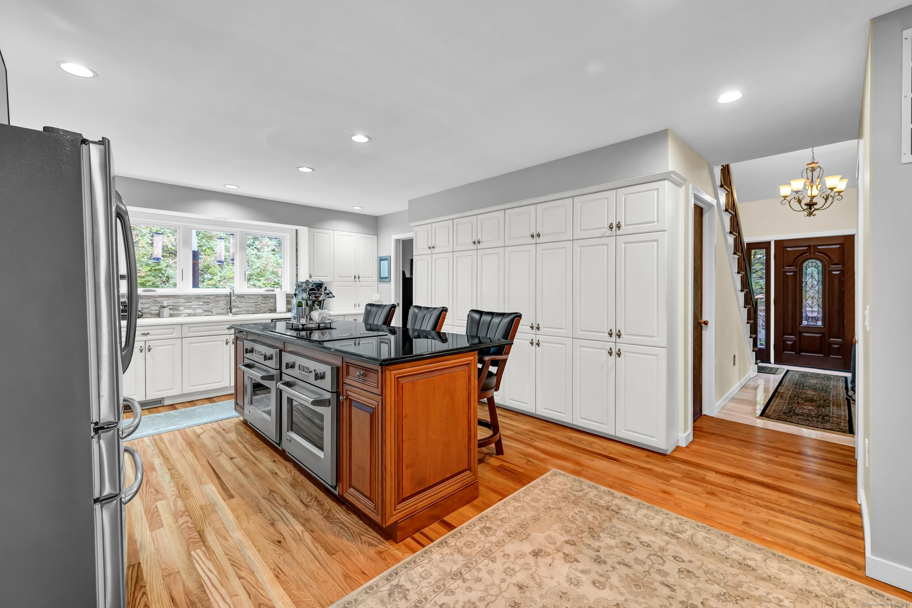 26 Cove Road Brookfield, CT 06804 - Photo 4 of 40 a kitchen with stainless steel appliances granite countertop a refrigerator a sink dishwasher a stove and a refrigerator with wooden floor