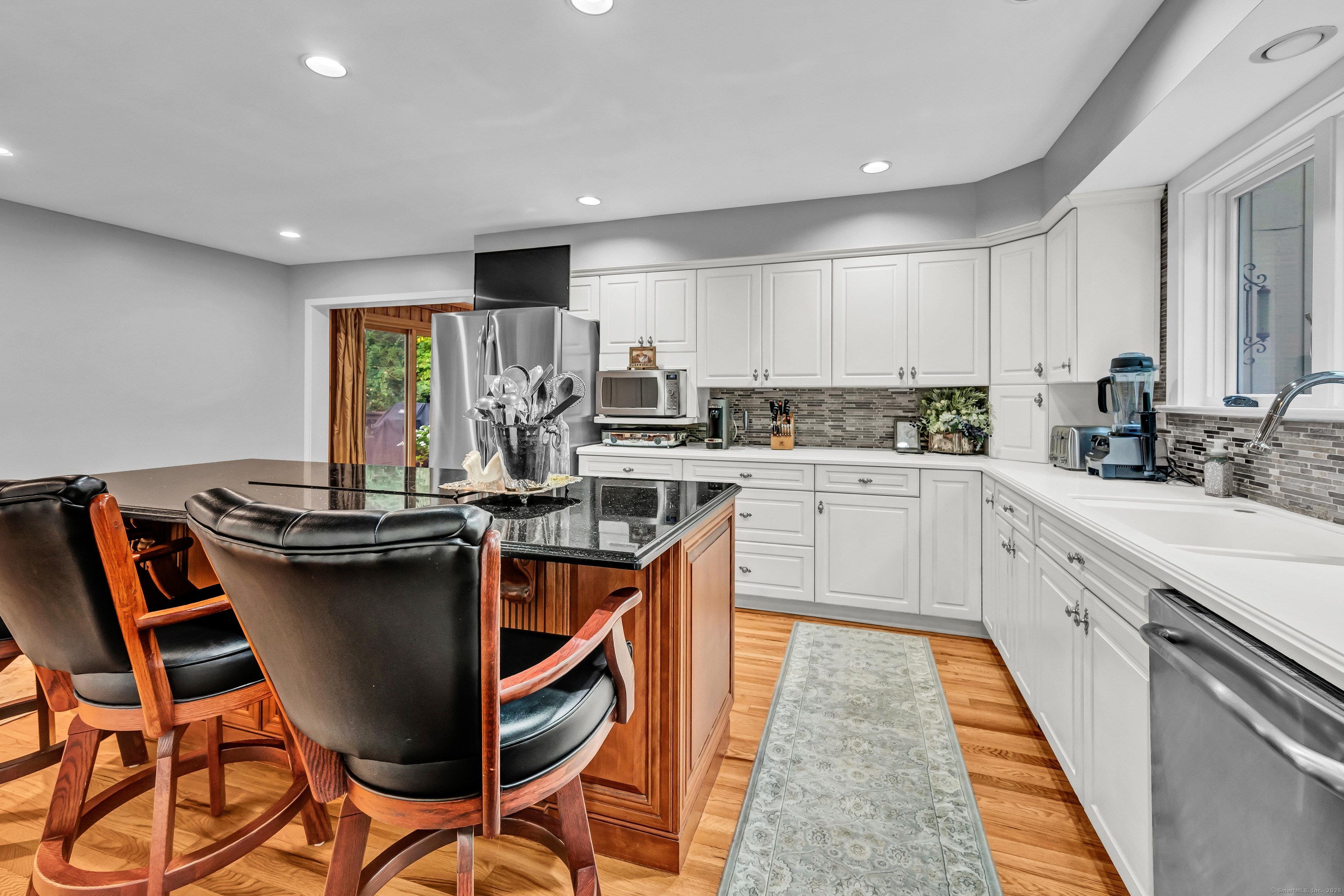26 Cove Road Brookfield, CT 06804 - Photo 5 of 40 a kitchen with kitchen island granite countertop wooden cabinets and white appliances