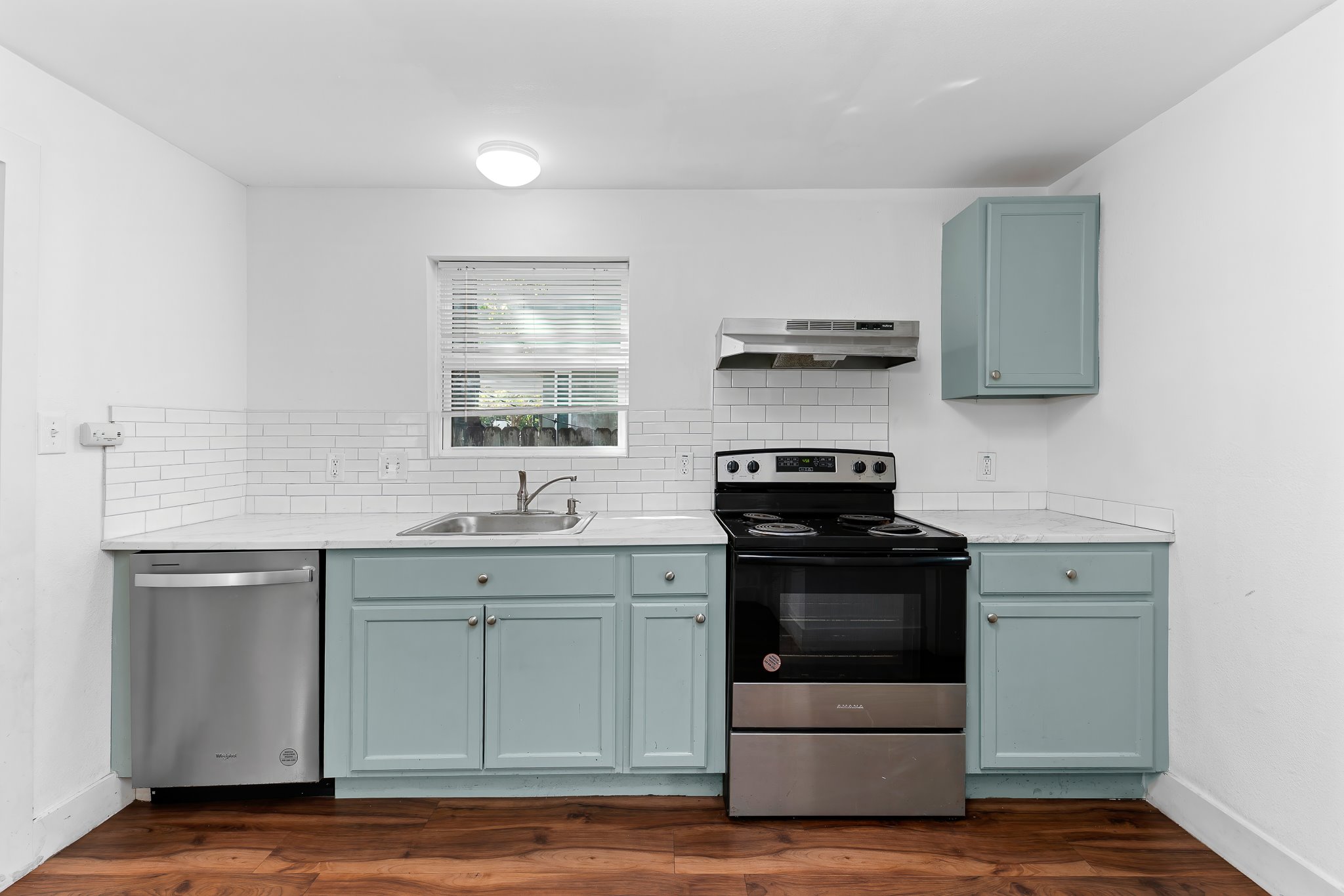 204 Lessin Lane Austin, TX 78704 - Photo 19 of 35 a kitchen with stainless steel appliances granite countertop a sink and stove top oven