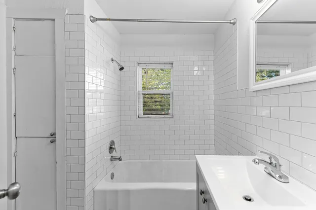 a bathroom with a sink a shower and a bathtub