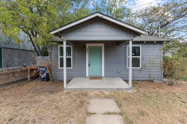 a view of a house with a yard and garage