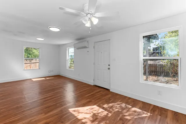 wooden floor in an empty room with a window