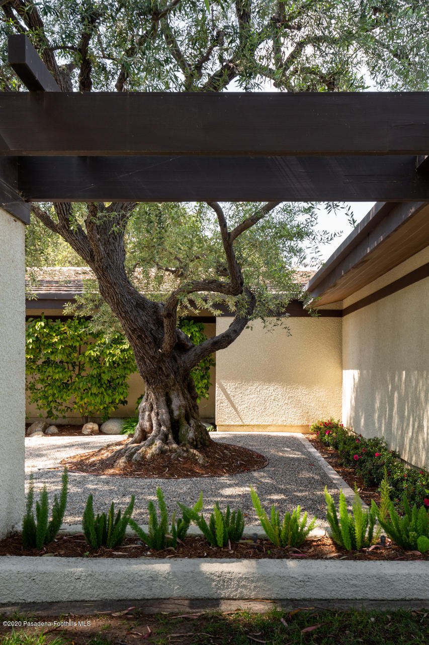 a view of a porch with furniture and a yard