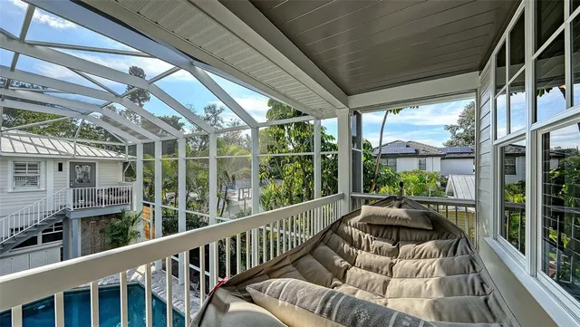 a view of a backyard with swimming pool table and chairs