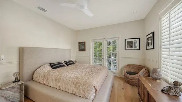 a view of a patio with table and chairs potted plants with wooden floor and plants
