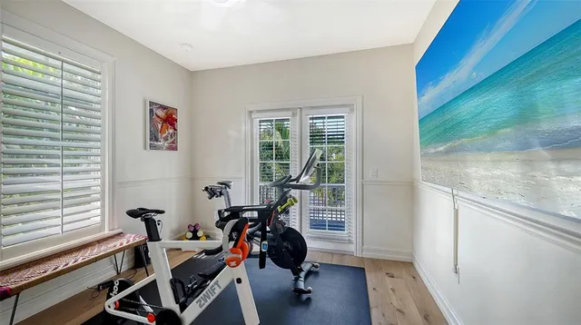 a view of a patio with chairs and table under an umbrella