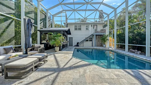 a view of a patio with table and chairs and potted plants