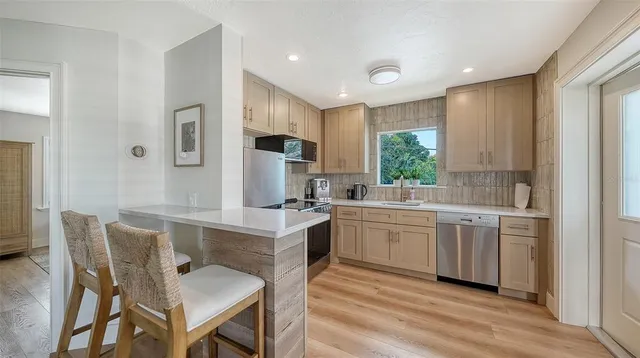 a outdoor space with patio the couches and pool with a dining table and chairs with wooden floor