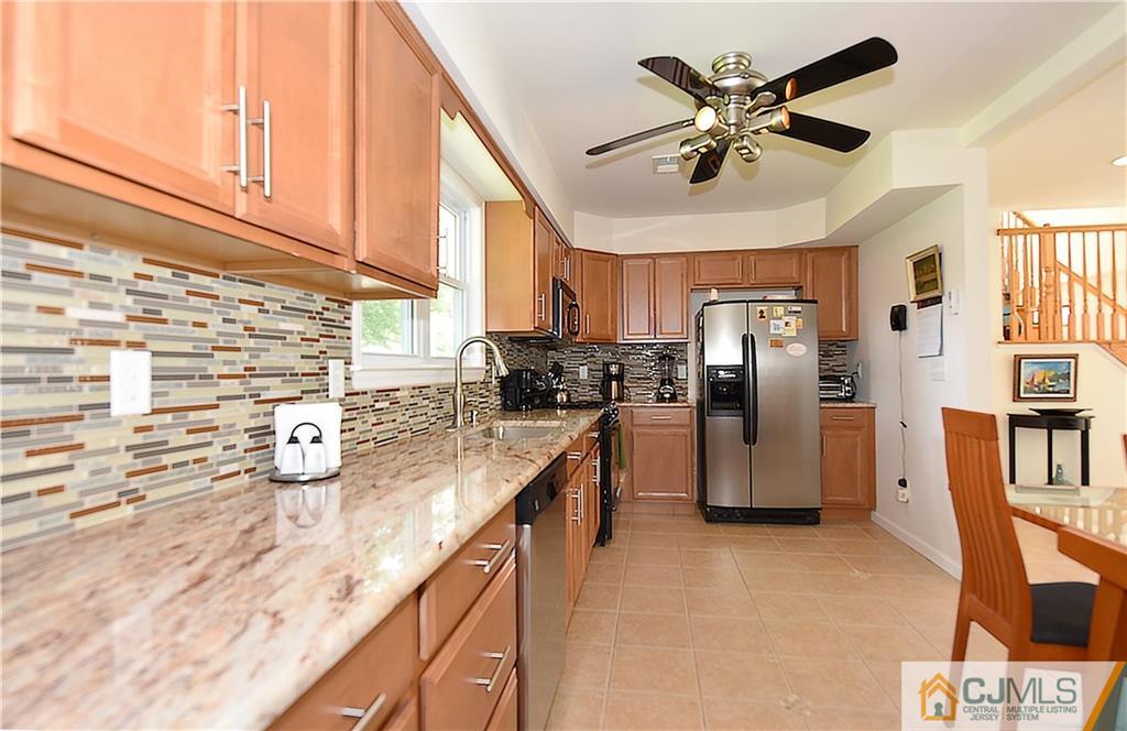 3 Caldwell Road Edison, NJ 08817 - Photo 11 of 25 a kitchen with stainless steel appliances kitchen island granite countertop a refrigerator a stove and a sink with cabinets