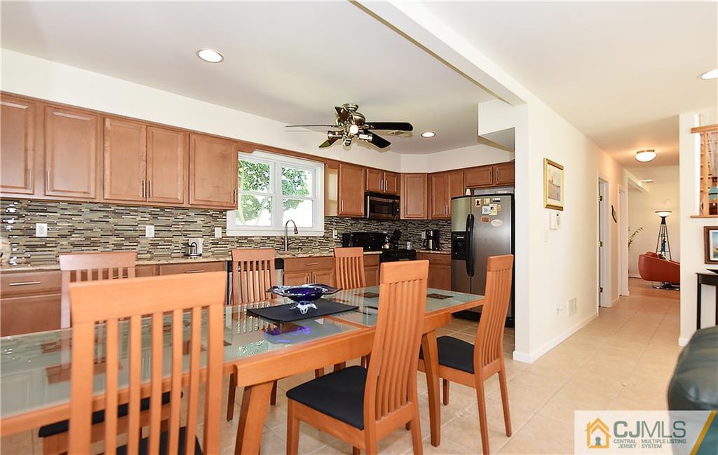 3 Caldwell Road Edison, NJ 08817 - Photo 13 of 25 a kitchen with stainless steel appliances granite countertop a refrigerator a sink dishwasher a stove and white countertops with wooden floor
