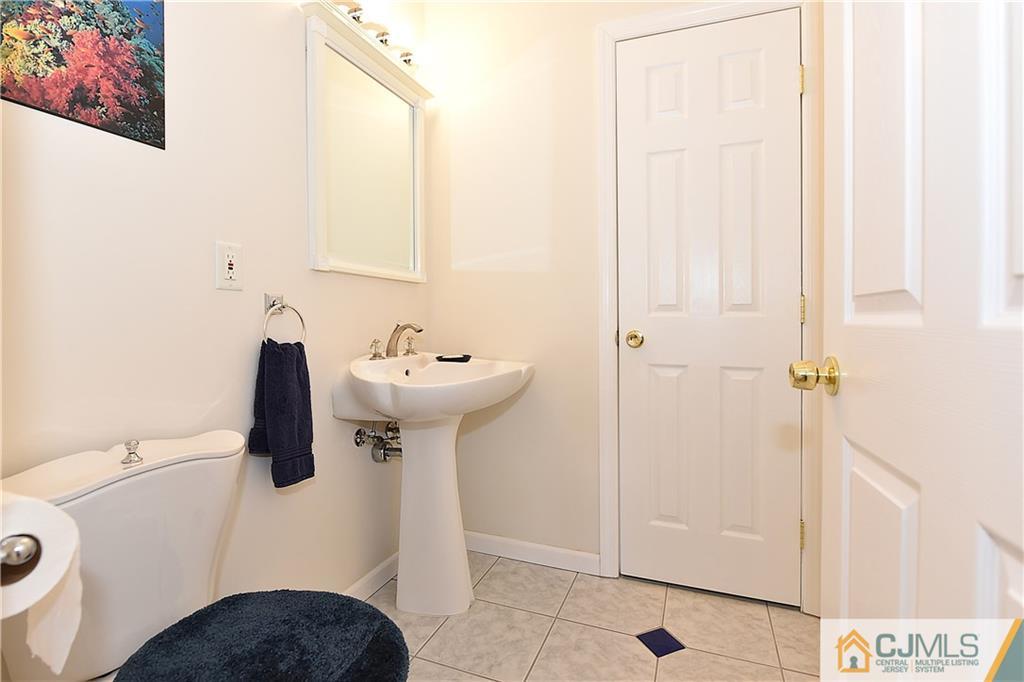 3 Caldwell Road Edison, NJ 08817 - Photo 15 of 25 a bathroom with a sink and mirror