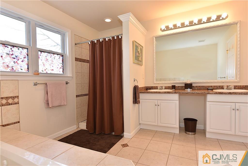 3 Caldwell Road Edison, NJ 08817 - Photo 18 of 25 a bathroom with a granite countertop sink and a mirror