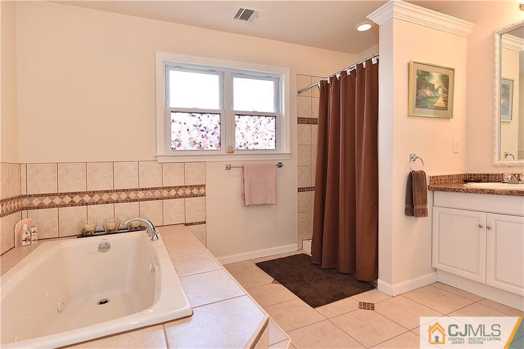 3 Caldwell Road Edison, NJ 08817 - Photo 19 of 25 a bathroom with a bathtub and a window