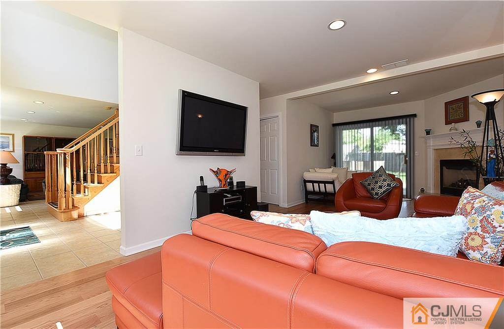 3 Caldwell Road Edison, NJ 08817 - Photo 6 of 25 a living room with fireplace furniture and a flat screen tv