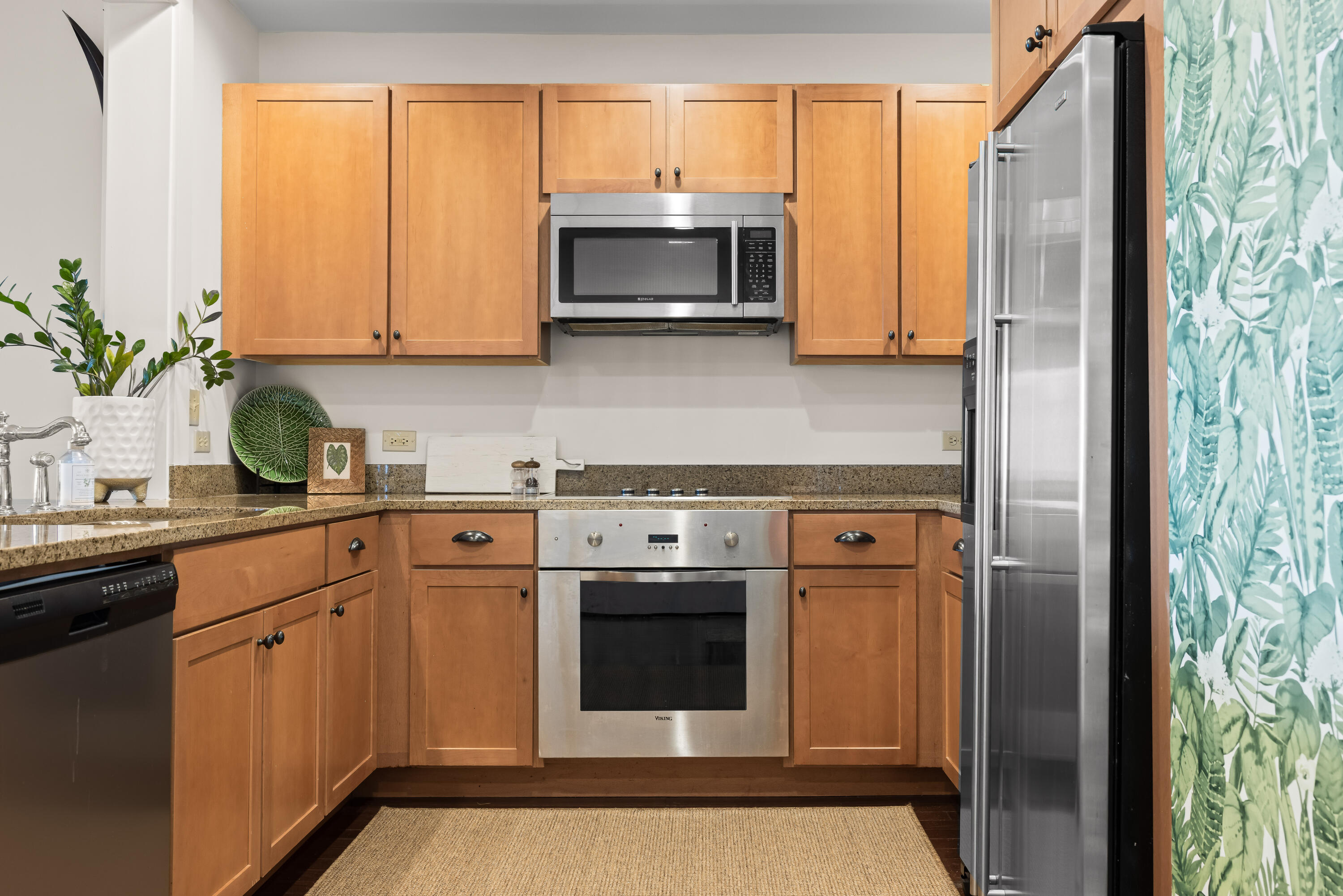 2046 West County Highway 30A, Unit M2428 Santa Rosa Beach, FL 32459 - Photo 16 of 72 a kitchen with stainless steel appliances a stove a sink and a microwave