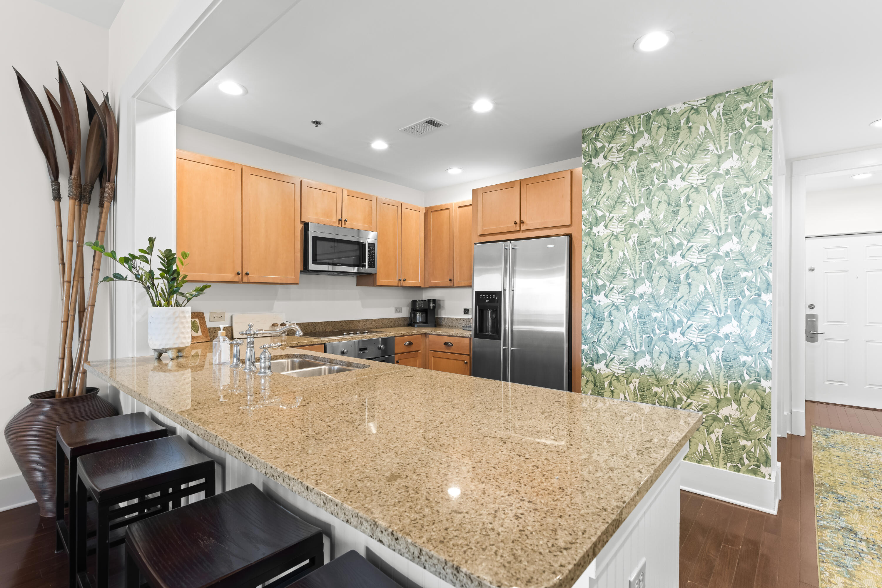 2046 West County Highway 30A, Unit M2428 Santa Rosa Beach, FL 32459 - Photo 18 of 72 a kitchen with kitchen island granite countertop a stove refrigerator and microwave