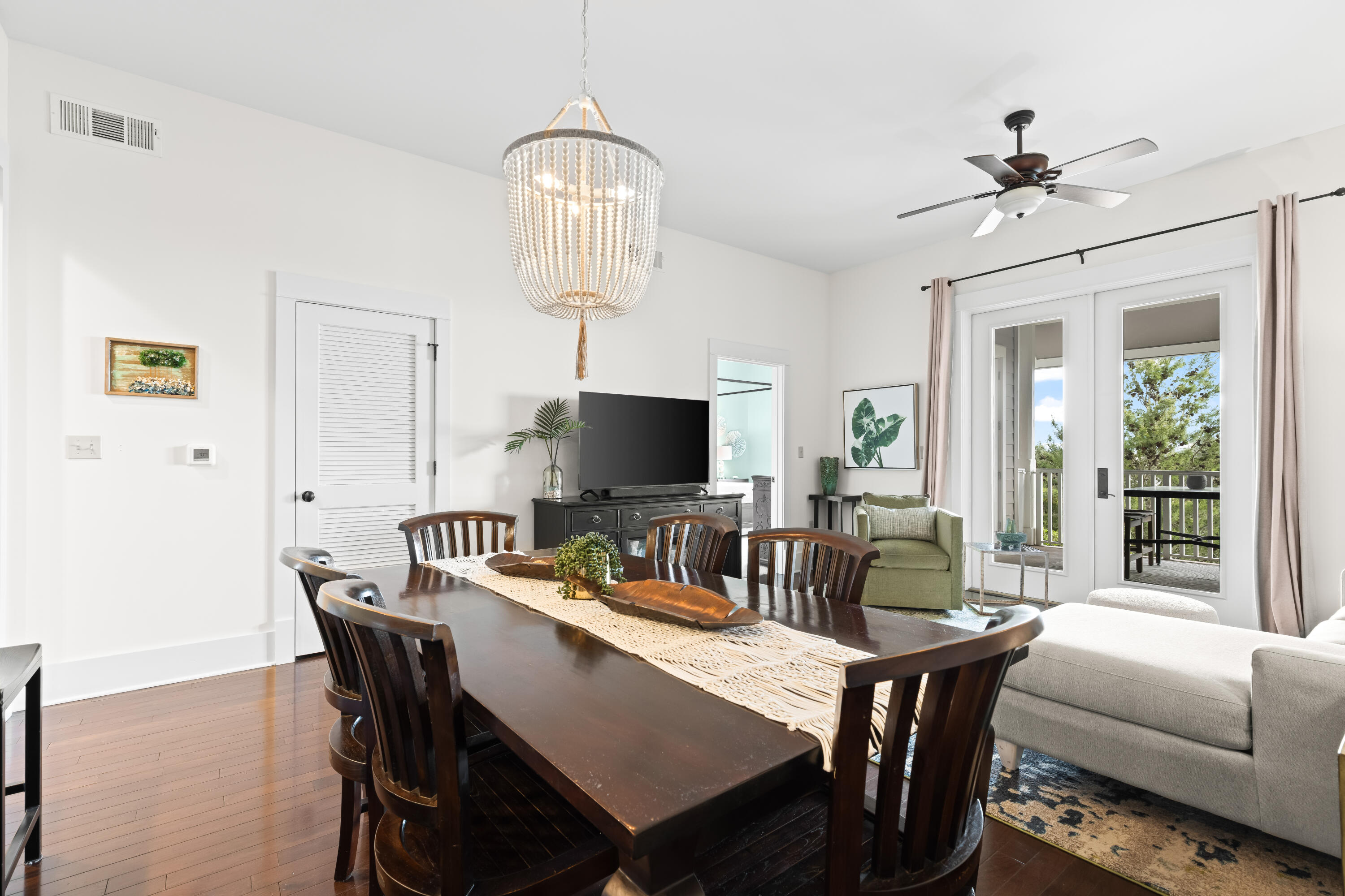 2046 West County Highway 30A, Unit M2428 Santa Rosa Beach, FL 32459 - Photo 22 of 72 a view of a dining room with furniture a chandelier and wooden floor