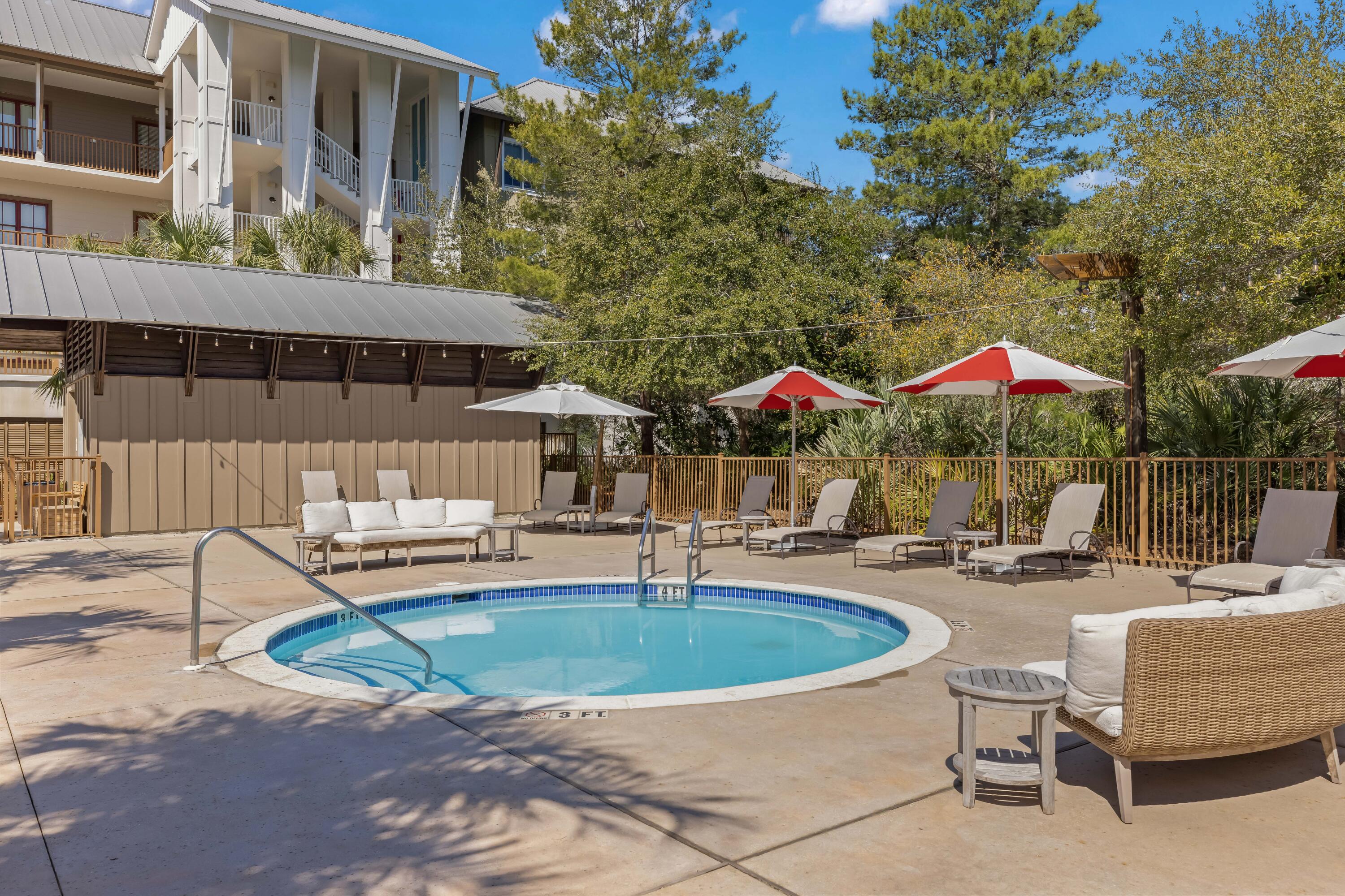 2046 West County Highway 30A, Unit M2428 Santa Rosa Beach, FL 32459 - Photo 58 of 72 a patio with a table and chairs