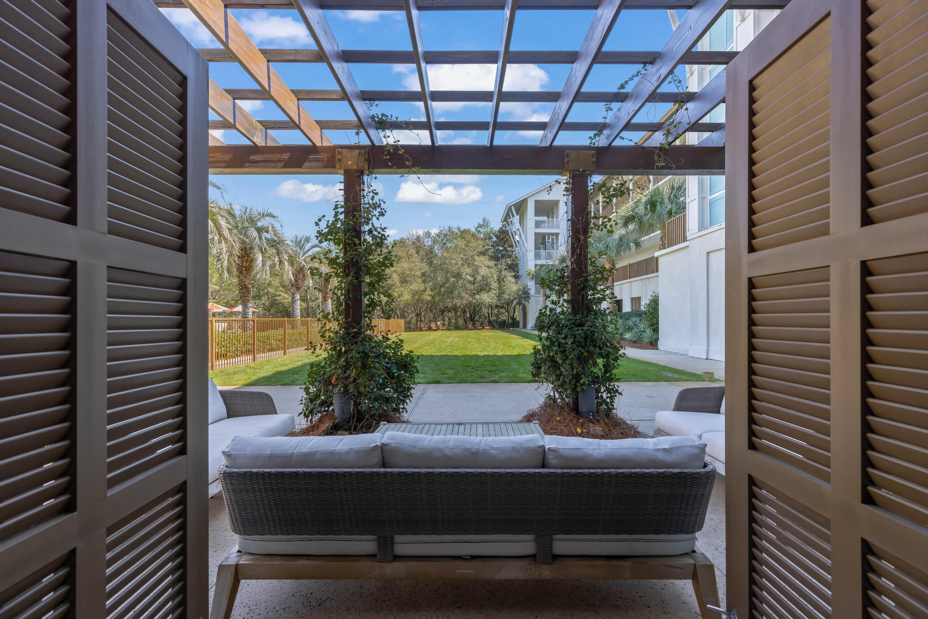 2046 West County Highway 30A, Unit M2428 Santa Rosa Beach, FL 32459 - Photo 68 of 72 a view of a porch with couches and wooden floor