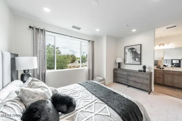 a bed room with a bed and a large window