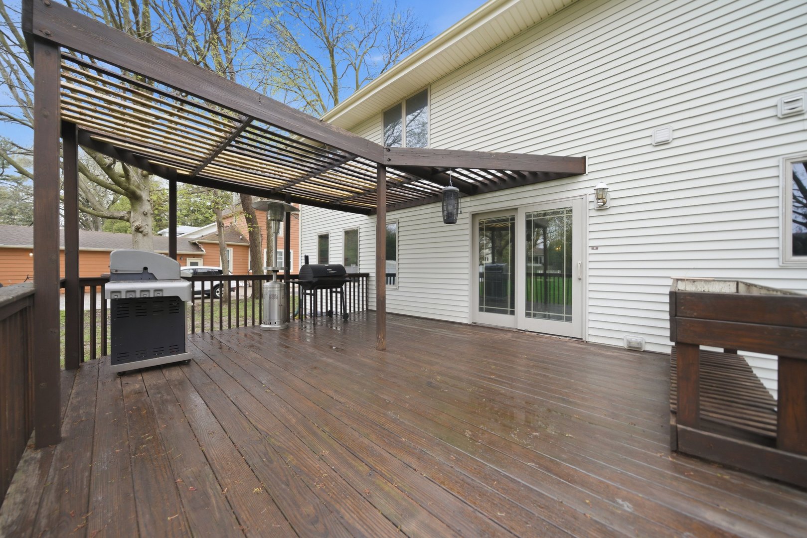 1016 North 7th Street Rochelle, IL 61068 - Photo 31 of 39 a view of a patio with table and chairs a barbeque with wooden floor and fence