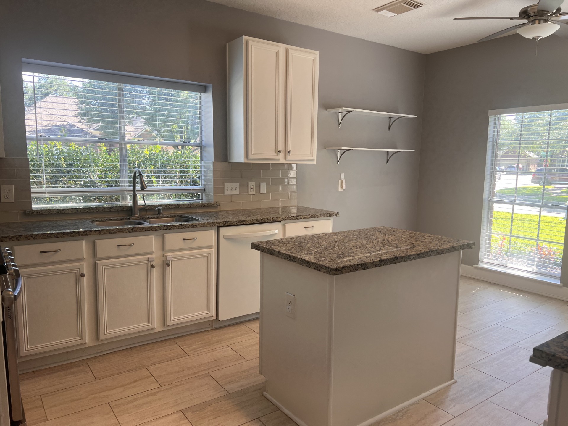 9327 Restover Lane Houston, TX 77064 - Photo 7 of 22 a kitchen with granite countertop a sink and a stove