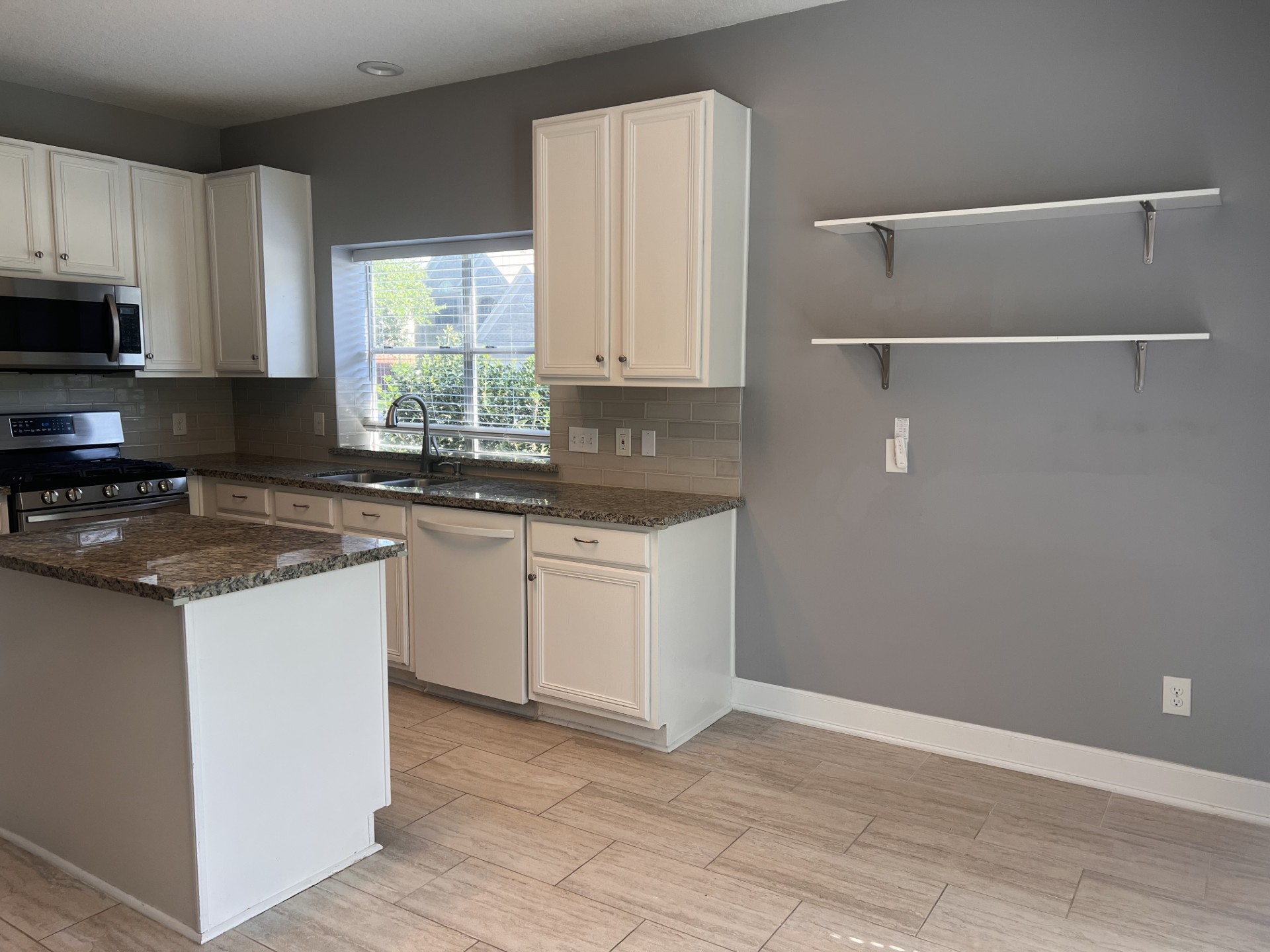 9327 Restover Lane Houston, TX 77064 - Photo 9 of 22 a kitchen with a sink cabinets and window